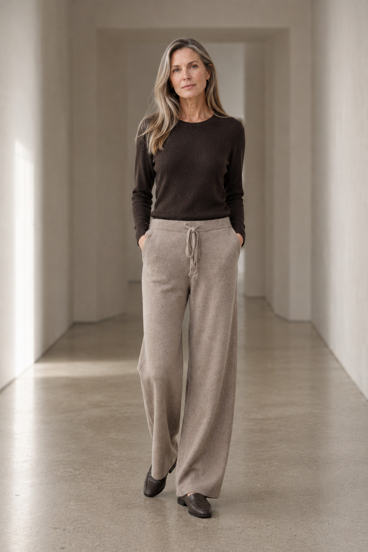 Camel Cashmere Blend Knit Lounge Pants on a mature woman in an empty hallway