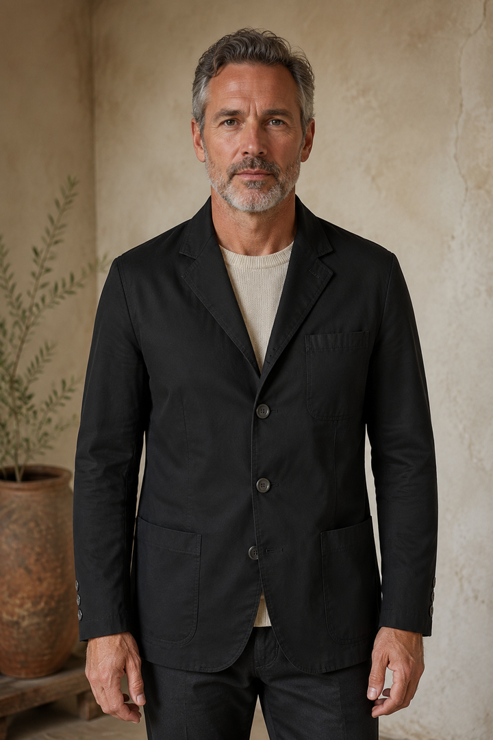 Black cotton three-button blazer hero, direct camera gaze