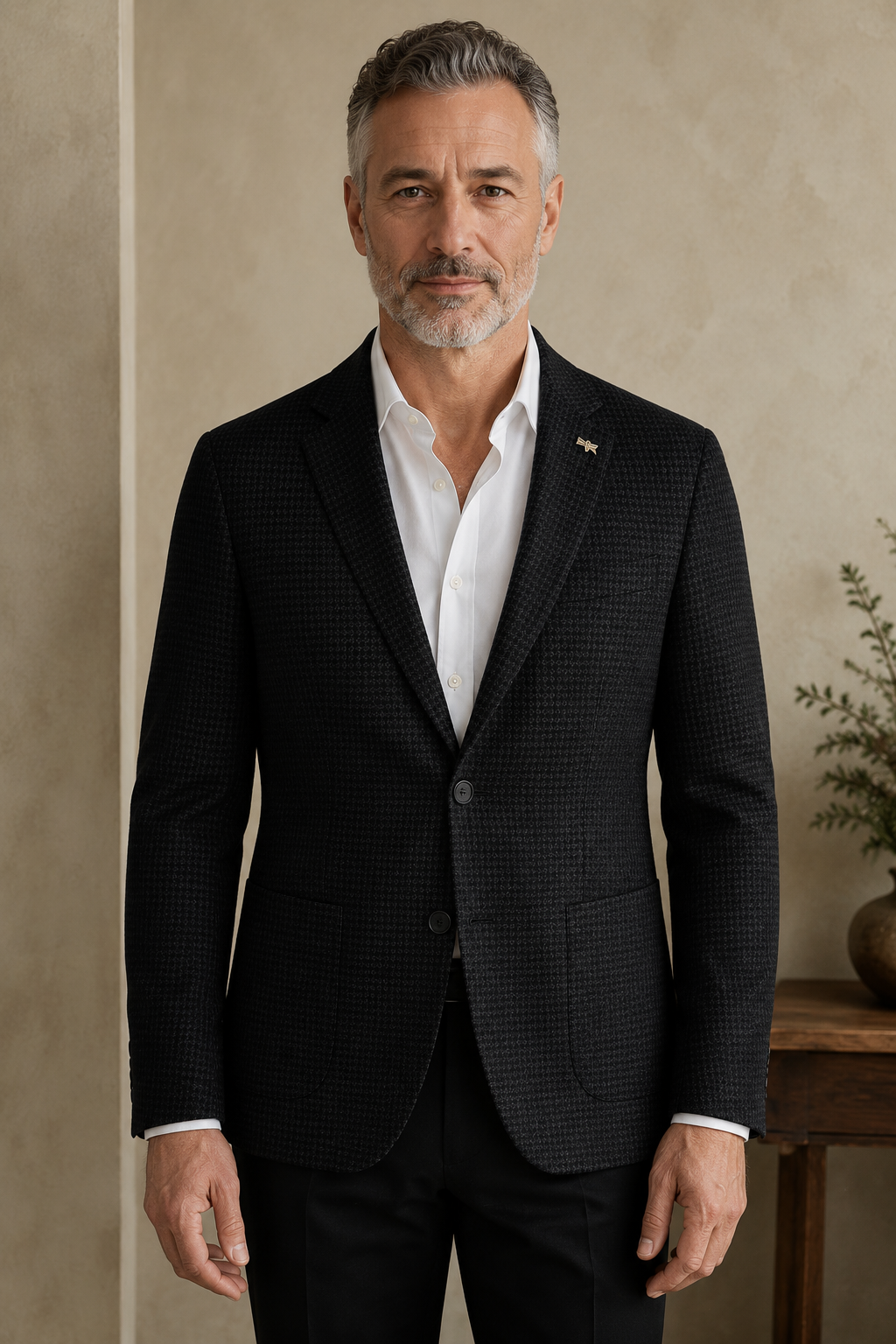 Black micro-pattern blazer hero, direct camera gaze