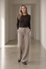 Camel Cashmere Blend Knit Lounge Pants on a mature woman in an empty hallway