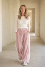 Pink Cotton Blend High Waist Joggers on a mature woman in an empty hallway