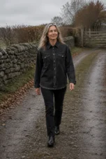 Genevieve black roomy heavy denim jacket on a rural autumn lane