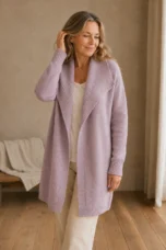 Gilbertine dusty-pink long shawl-collar cardigan on the main product model, gently touching her hair