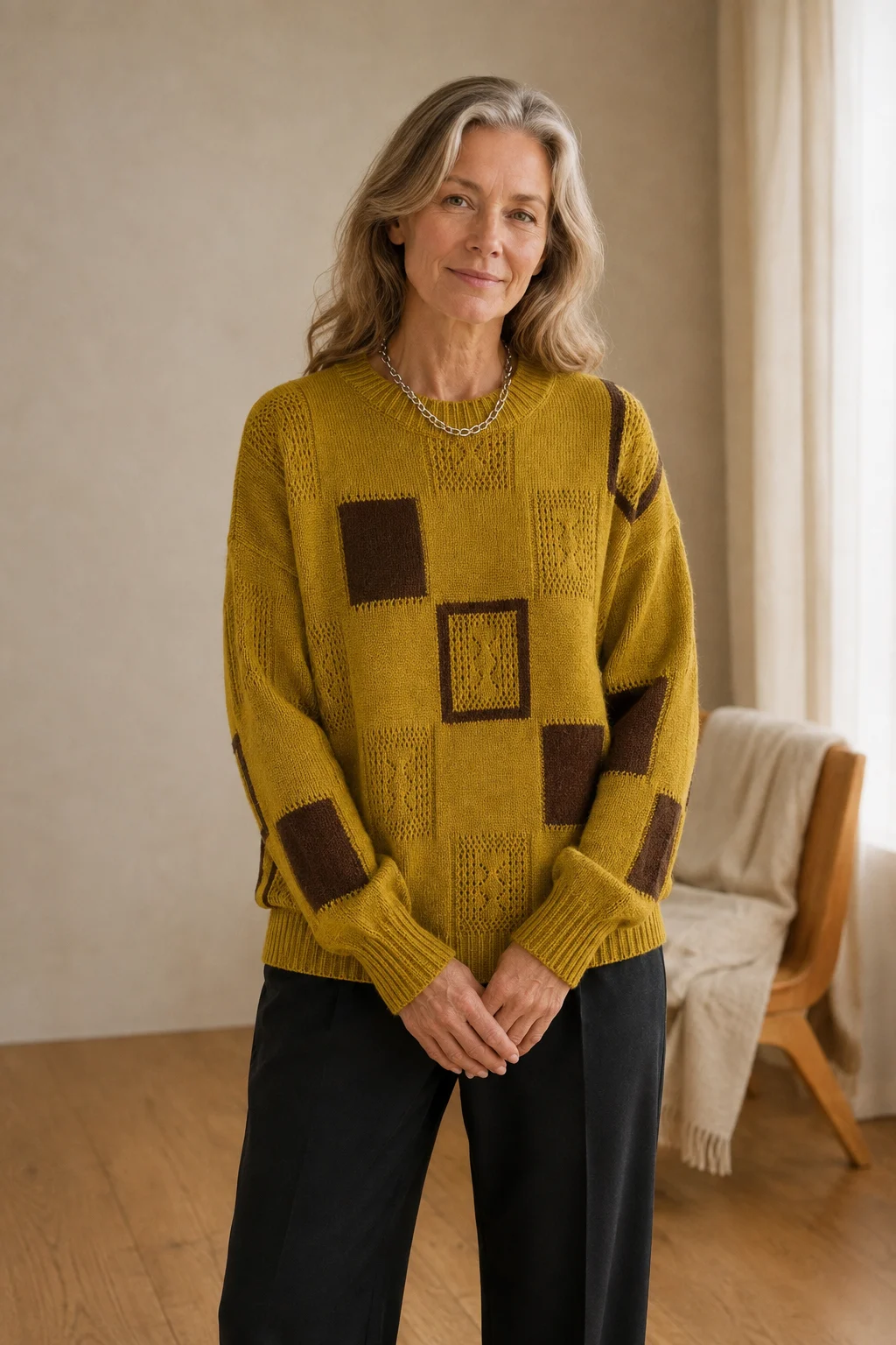 Grace mustard-yellow geometric knit sweater with brown square motifs, main product model with hands loosely crossed