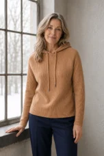 Graziella camel rib-knit drawstring hoodie, main product model resting one hand naturally on a windowsill