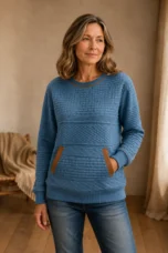 Hattie blue textured cotton sweatshirt with brown-trimmed pockets, main product model with one hand in the sweatshirt pocket