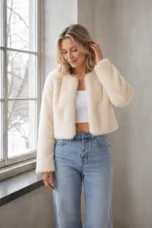 Idola cream cropped faux-fur jacket, main product model gently tucking her hair behind her ear