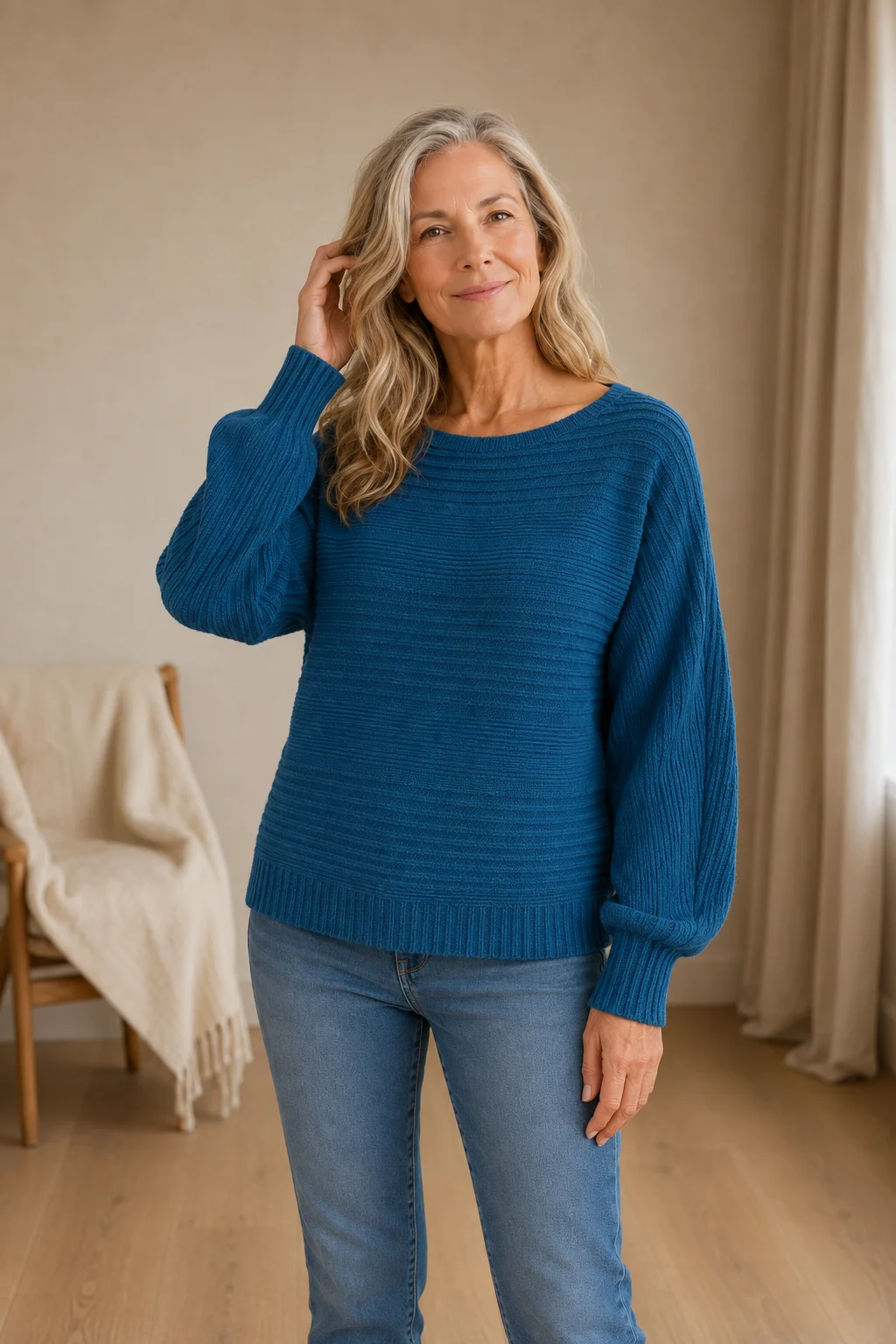 Jane blue rib-knit sweater on the main product model, one hand gently touching her hair