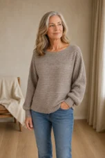 Jane khaki rib-knit sweater on the main product model, with one hand in her jeans pocket