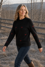 Janet Raglan Crew Neck Wool Sweater in black, outdoor editorial view