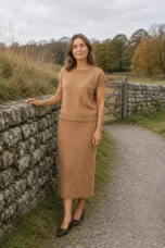 Noella camel ribbed sleeveless matching set beside an autumn stone wall