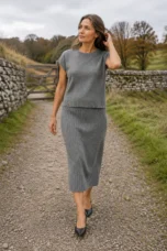 Noella grey ribbed sleeveless matching set walking through a cool autumn landscape