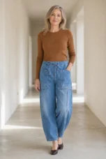 Light blue Relaxed Cotton Denim Jeans on a mature woman in an empty hallway