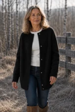 Rosilda Fine Gauge Wool Cardigan in black, natural walking editorial view