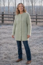 Rosilda Fine Gauge Wool Cardigan in light green, outdoor editorial view