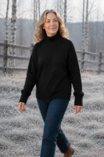 Selma Drop Shoulder Mock Neck Sweater in Black, outdoor editorial photograph