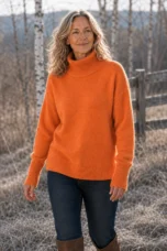 Zelina orange high neck merino pullover editorial photograph